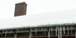 snow and icicles on roof and gutters